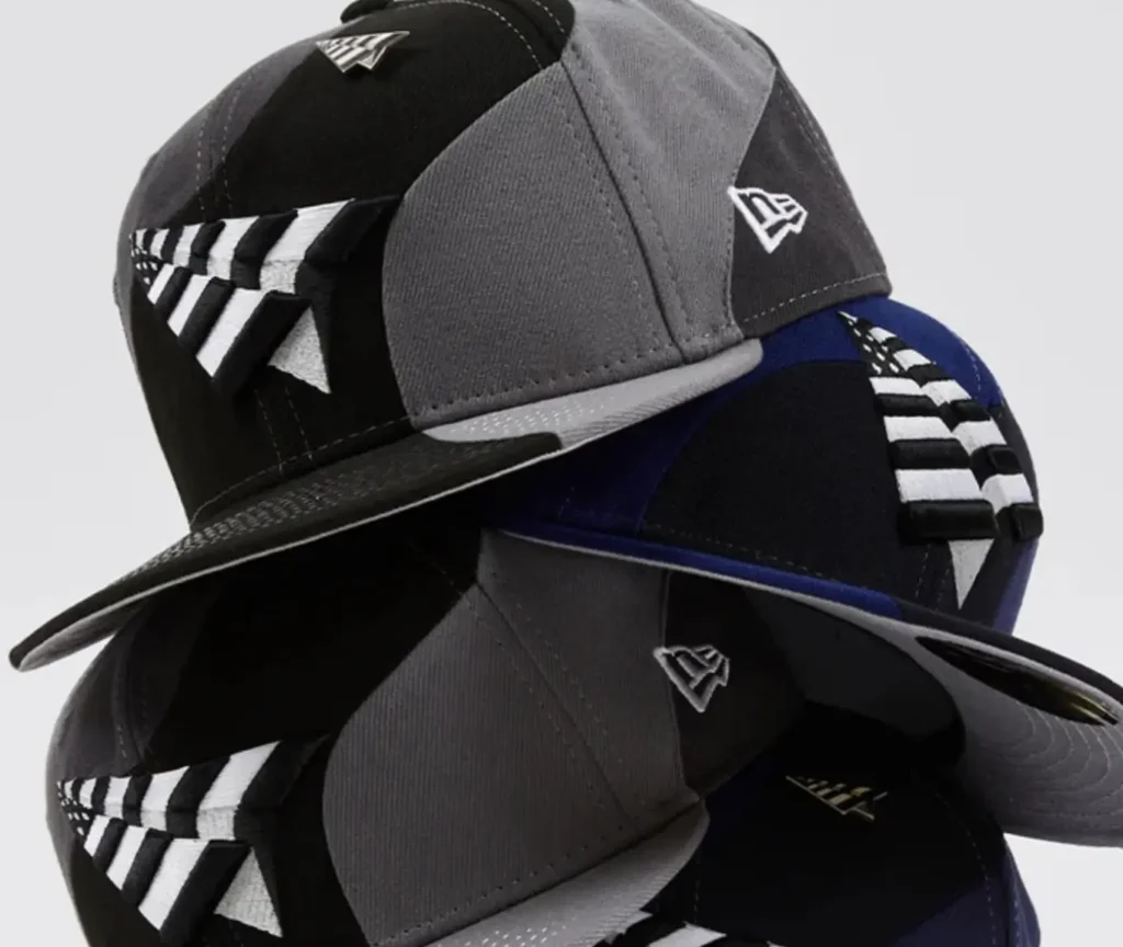 A stacked display of Planes Spiral 9Fifty Snapback Crowns by New Era in black, grey, and navy colorways, featuring 3D embroidered spiral plane logos and the New Era flag on the side, showcasing their structured six-panel construction and flat visors