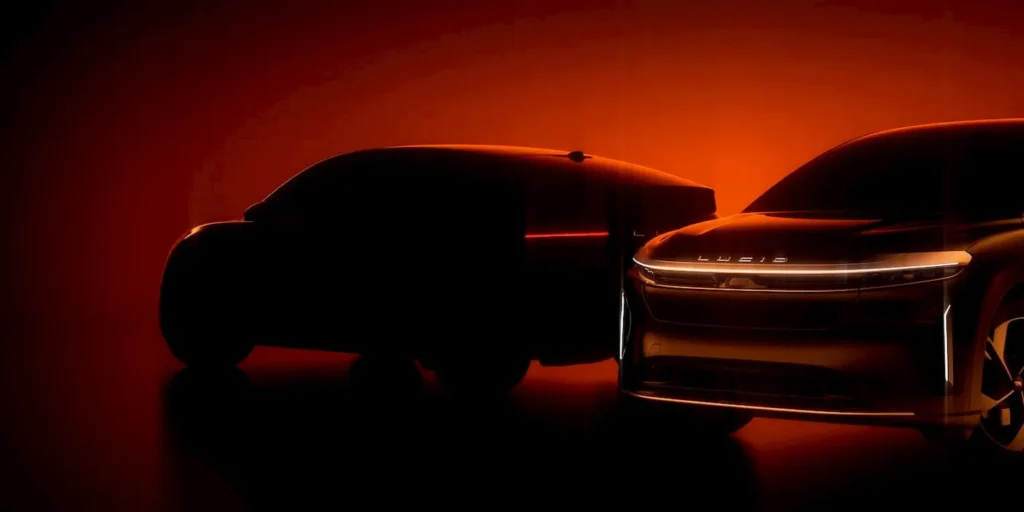 Teaser silhouette of two Lucid electric vehicles—one midsize crossover and one sedan—glowing against a deep amber-red gradient background, emphasizing the brand’s futuristic design and “mind-off” autonomous vision