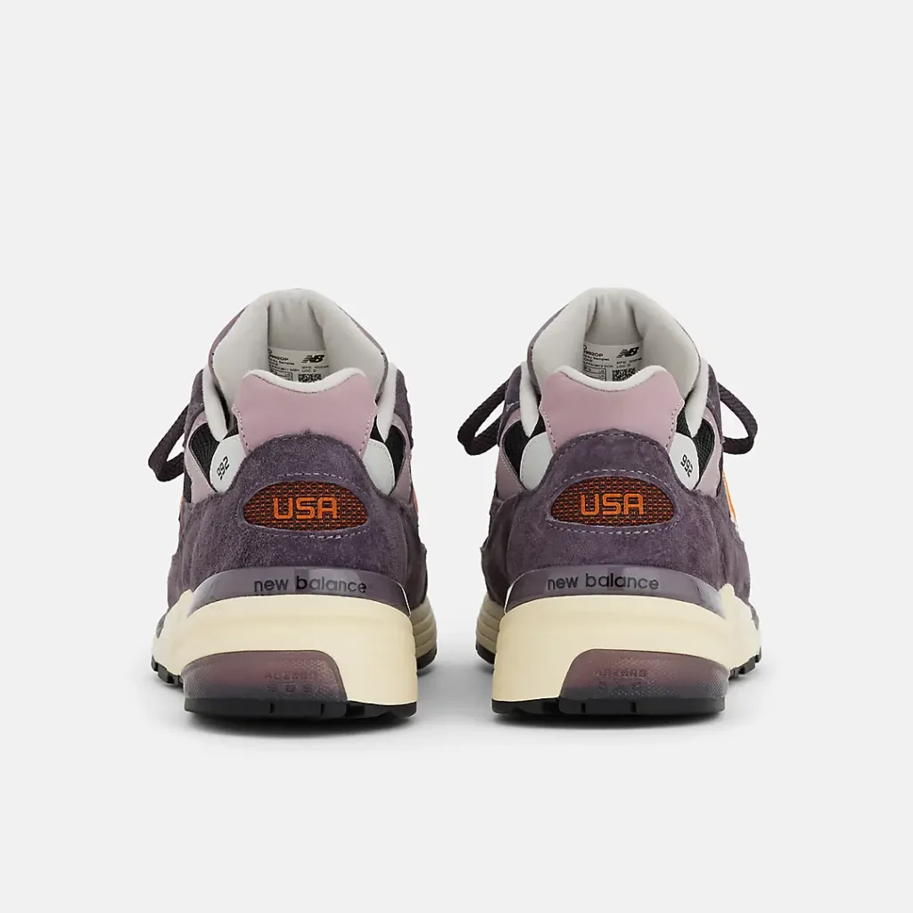Rear view of the New Balance Made in USA 992 “Dark Ice Wine,” showing purple suede heels with orange mesh USA branding, lilac heel tabs, cream midsoles, and black rubber outsoles
