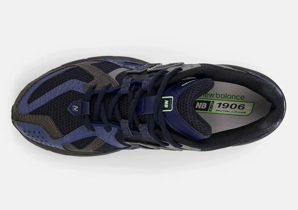 Top-down view of the New Balance 1906U ‘Eclipse’ showing navy mesh upper, charcoal overlays, navy laces, and green-accented insole branding