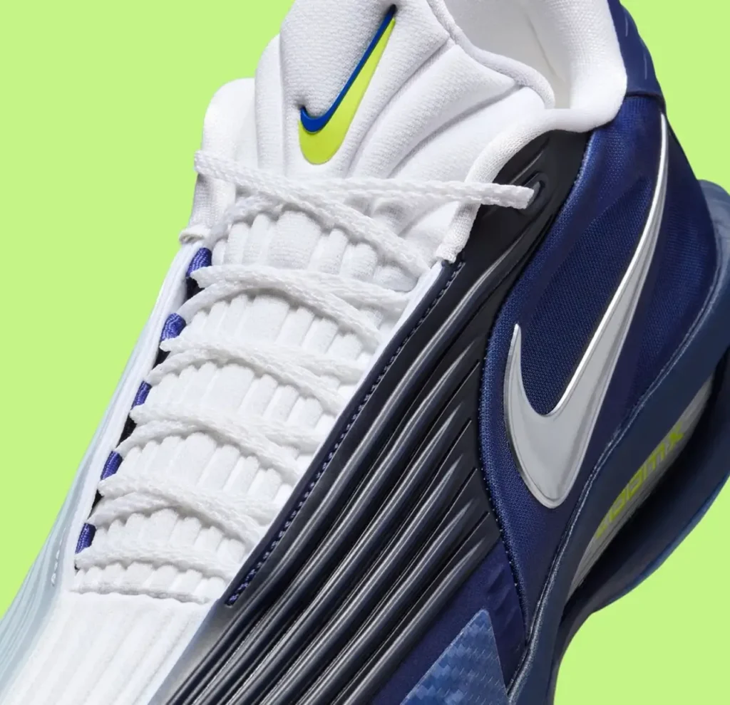 A pair of Nike GT Cut 3 Turbo sneakers in a Dallas Mavericks-inspired colorway, featuring asymmetrical navy and ice-blue uppers with white woven tongues, metallic silver Swooshes, and translucent blue outsoles, photographed against a bright lime-green background