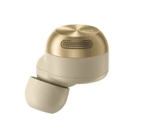 Close-up view of the Technics EAH-AZ100 earbud in its new Champagne Gold finish, showing the brushed metallic top cap, precision-cut speaker grille, and matte beige silicone tip that highlights the premium build and ergonomic design