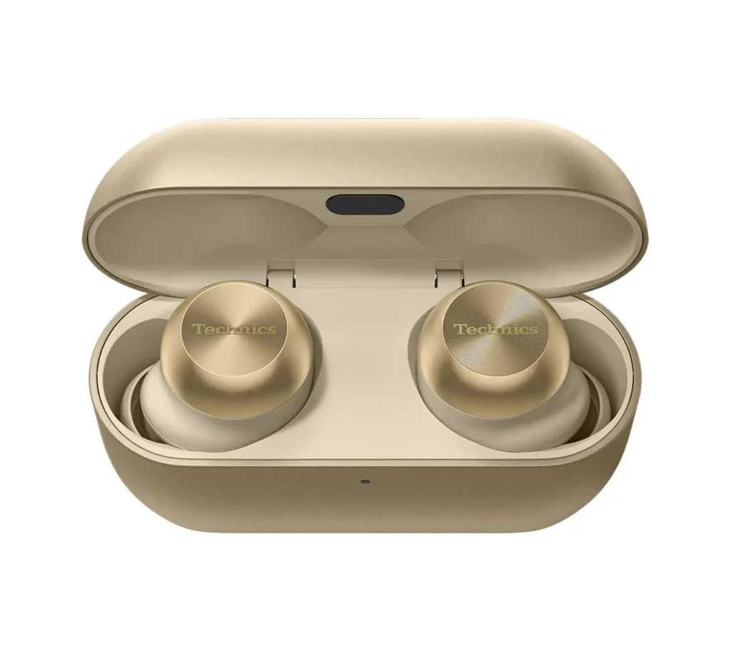 Technics EAH-AZ100 earbuds in Champagne Gold resting inside their open charging case, showcasing the brushed metallic finish, engraved Technics logo, and refined compact design