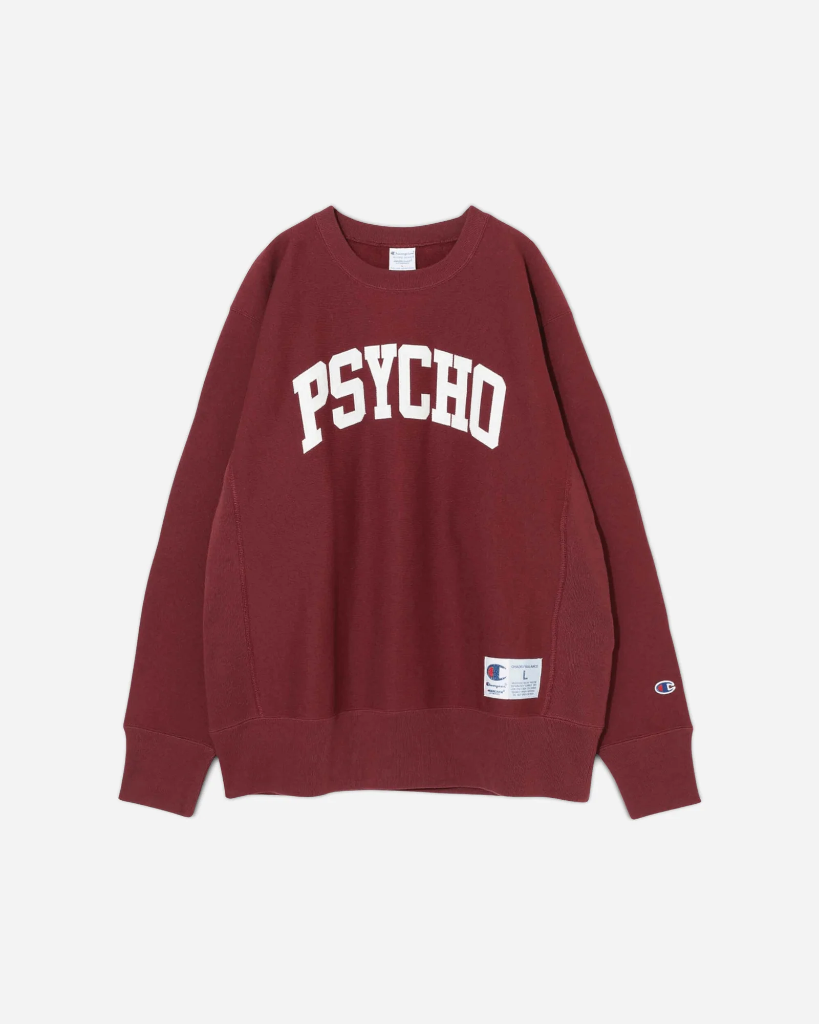 A burgundy Undercover x Champion crewneck sweatshirt featuring the bold white “PSYCHO” graphic across the chest, with Champion branding on the sleeve and a woven label near the hem