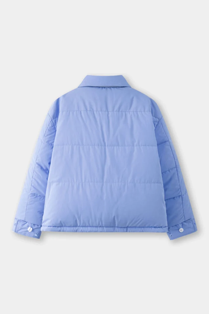 The back view of a light blue shirt-style puffer jacket, showing its clean quilted panels, structured collar, and buttoned cuffs