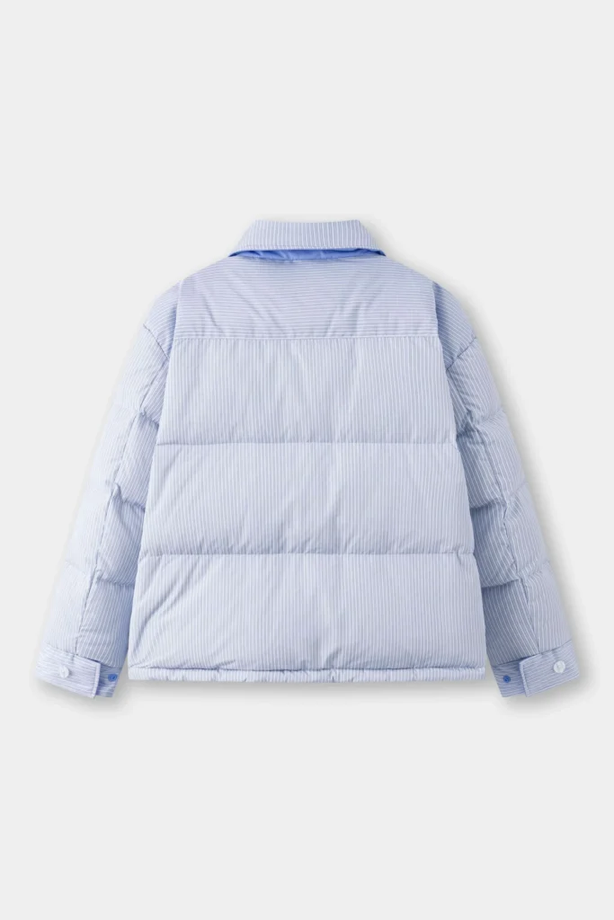 Back view of a light blue pinstripe puffer jacket designed like a shirt, showing its quilted padding, structured collar, and buttoned cuffs