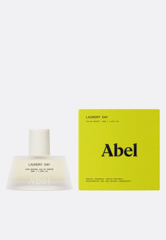 A minimalist photo of Abel’s Laundry Day Eau de Parfum 50ml, featuring the frosted-glass bottle with a white cap beside its bright yellow box displaying the Abel logo