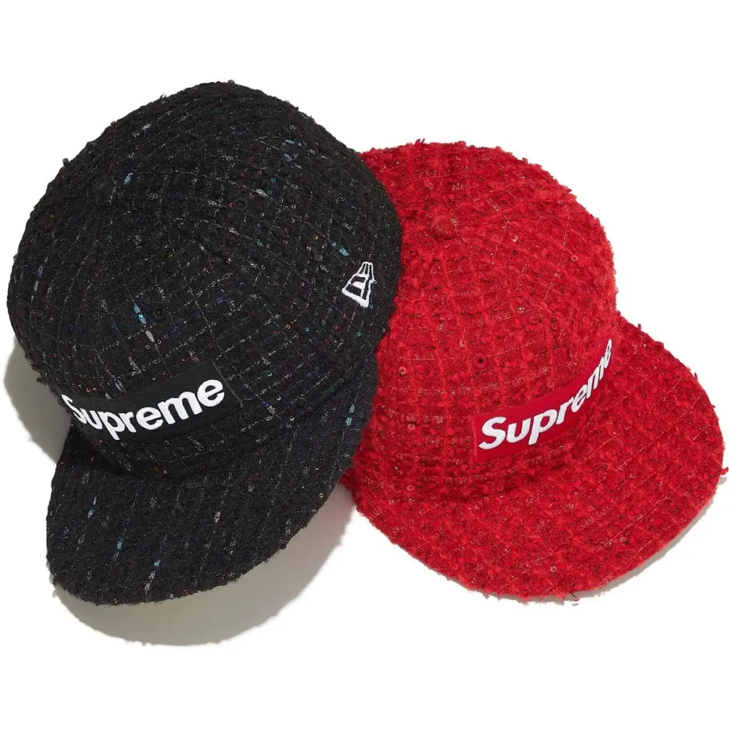 Two Supreme Fall/Winter 2025 Bouclé Box Logo New Era caps, one in black and one in red, featuring textured bouclé fabric with scattered sequins and bold Supreme box logos across the front