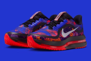 Nike Pegasus Premium “Bright Crimson” displayed on a minimalist studio background, showcasing its sculpted triple-layer midsole with glowing red accents, white engineered mesh upper, and visible full-length Air Zoom cushioning system that runs from heel to toe.