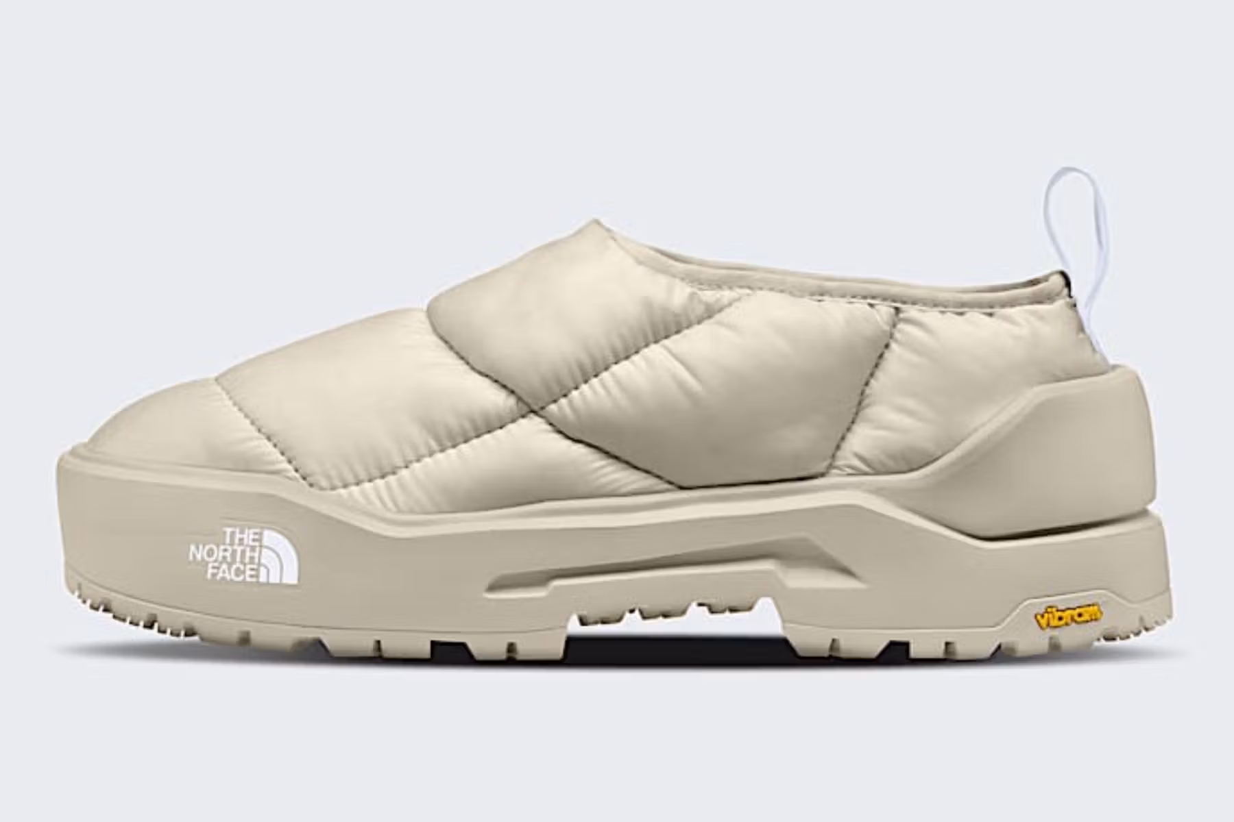 The North Face Nuptse Traction Chukka photographed in alpine snow, showcasing its puffed 700-fill down insulation, durable rubber outsole, and ankle-height silhouette inspired by the brand’s mountaineering heritage