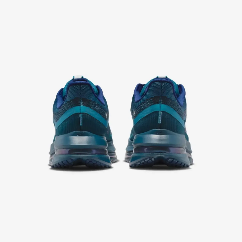 Rear view of the Swarovski × Nike Pegasus Premium SE WMNS “Blue Force” sneakers showing the sculpted heel structure, reflective teal overlays, and visible Air Zoom cushioning in the midsole. The gradient blue tones and heel pull tabs emphasize the shoe’s sleek, performance-driven silhouette
