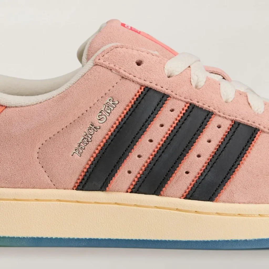 Side view close-up of the SpongeBob SquarePants x adidas Superstar “Patrick Star” showing the pink suede upper, black Three Stripes with coral stitching, and metallic “Patrick Star” text above the stripes, captured against a light background