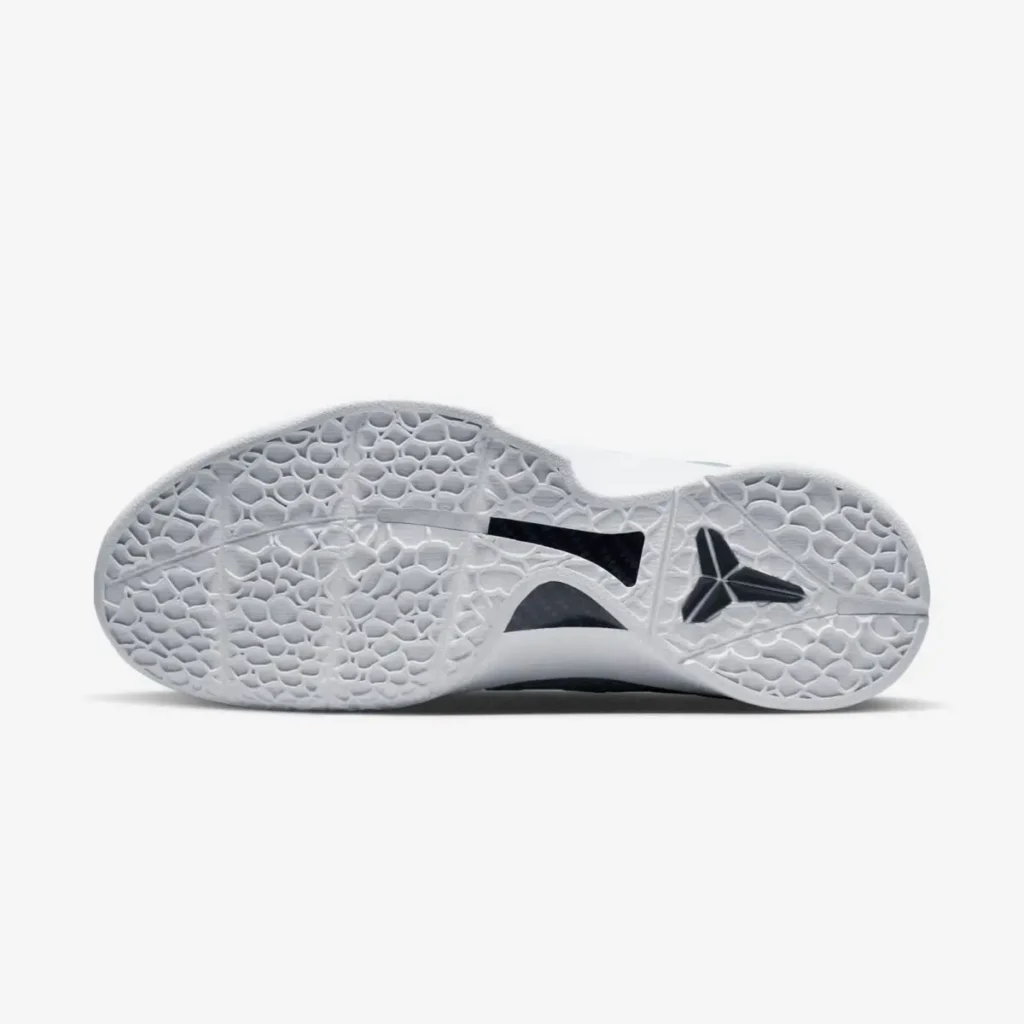 The underside of the Nike Kobe 6 Protro “Caitlin Clark,” showing the white translucent outsole with its signature snake-scale traction pattern. A black Kobe sheath logo appears near the forefoot, while a midfoot shank is visible through a cutout in the sole