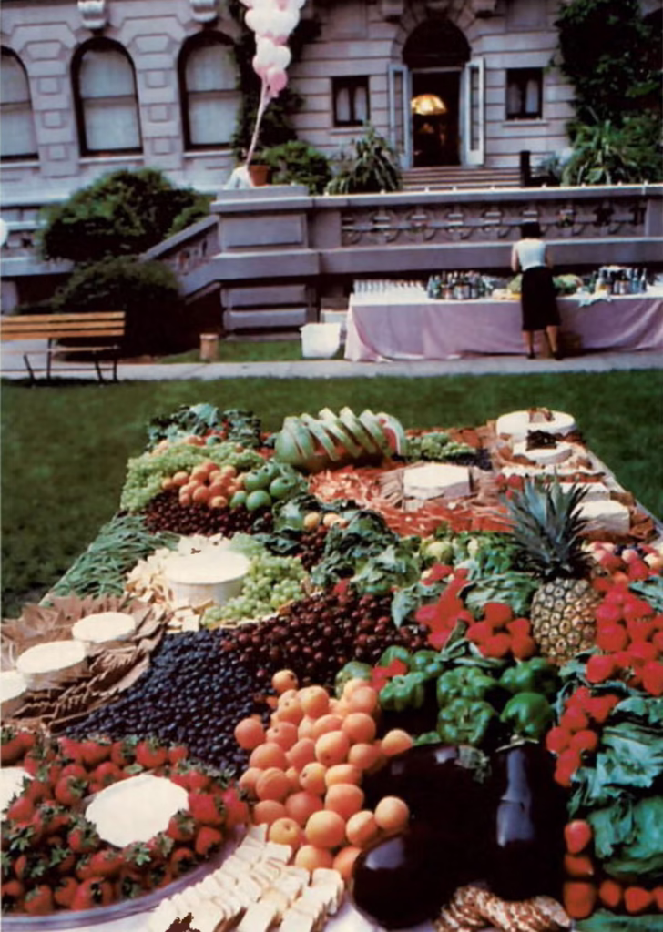 Archival photograph from Martha Stewart’s Entertaining showing a vintage dining table decorated with crystal glassware, floral centerpieces, and layered linens in warm lighting, capturing the elegant domestic aesthetic of the 1982 original ahead of its 2025 facsimile reissue