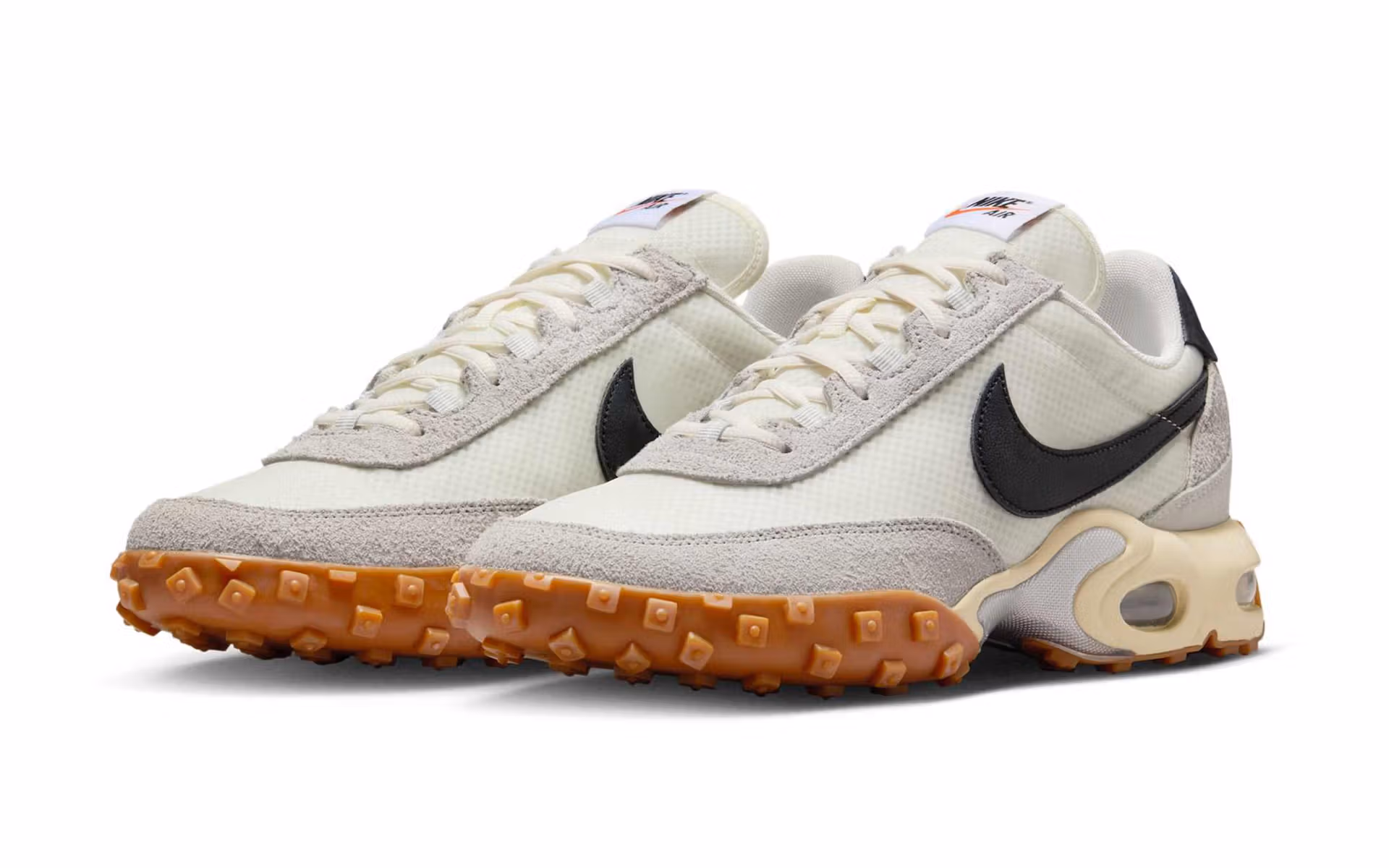 Nike Air Max Waffle SP “Sail” sneaker in off-white tones featuring layered nylon, suede, and leather panels, translucent heel clip, and a gum waffle outsole; photographed in studio lighting on a neutral background showing its retro-inspired silhouette and visible Air Max cushioning.