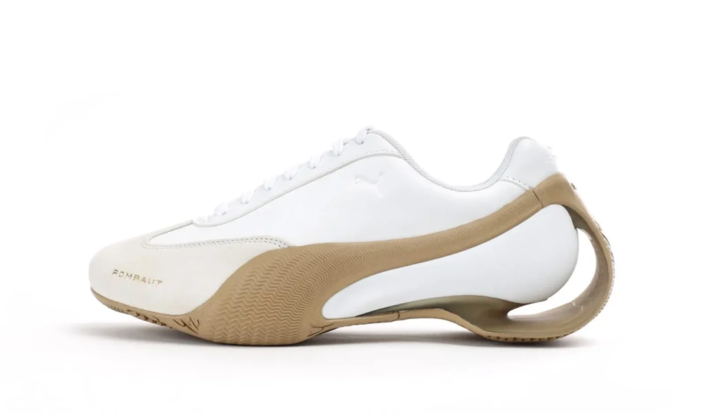 White PUMA x ROMBAUT Season 2 sneaker in a side profile view, featuring a soft suede toe, minimalist white upper, and sculptural gum sole with ROMBAUT’s signature circular heel cutout, photographed on a clean white background