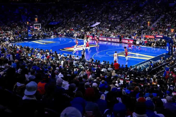 Crowd-filled arena during an NBA Cup game, featuring the tournament’s signature blue court design as teams compete in fast-break action