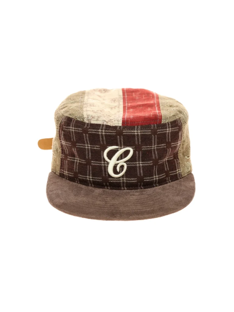 Front view of the 6CRAYON Vintage Patchwork Flat Top Baseball Cap, featuring mixed fabric patchwork panels in earthy tones, a flat crown, a brown suede-style brim, and an embroidered “C” logo centered on the front, photographed on a clean white background