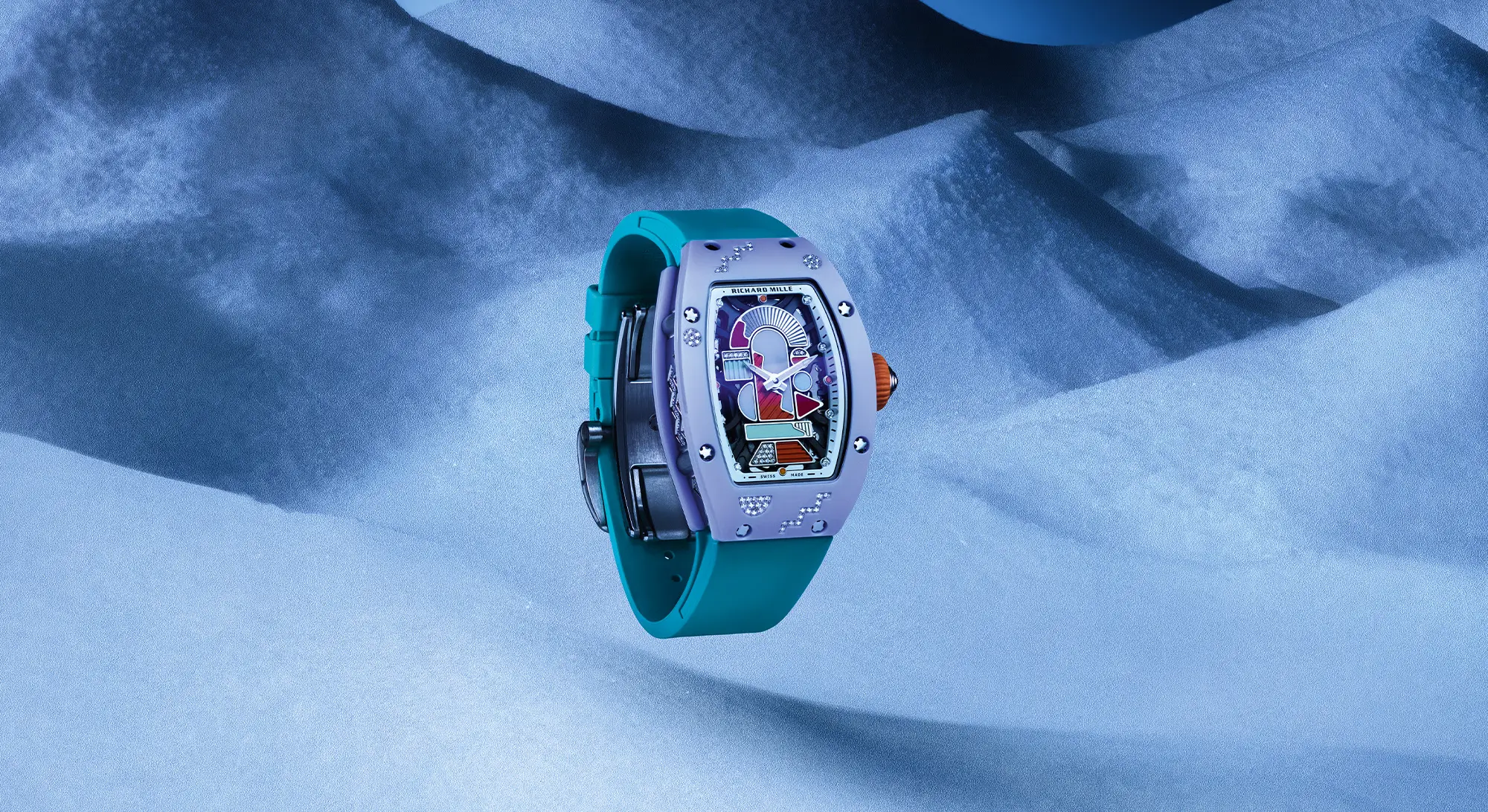 Floating Richard Mille RM 07-01 coloured ceramic watch with a lavender case, diamond-set accents, and a turquoise strap, displayed against a soft blue textured backdrop highlighting its sculptural design