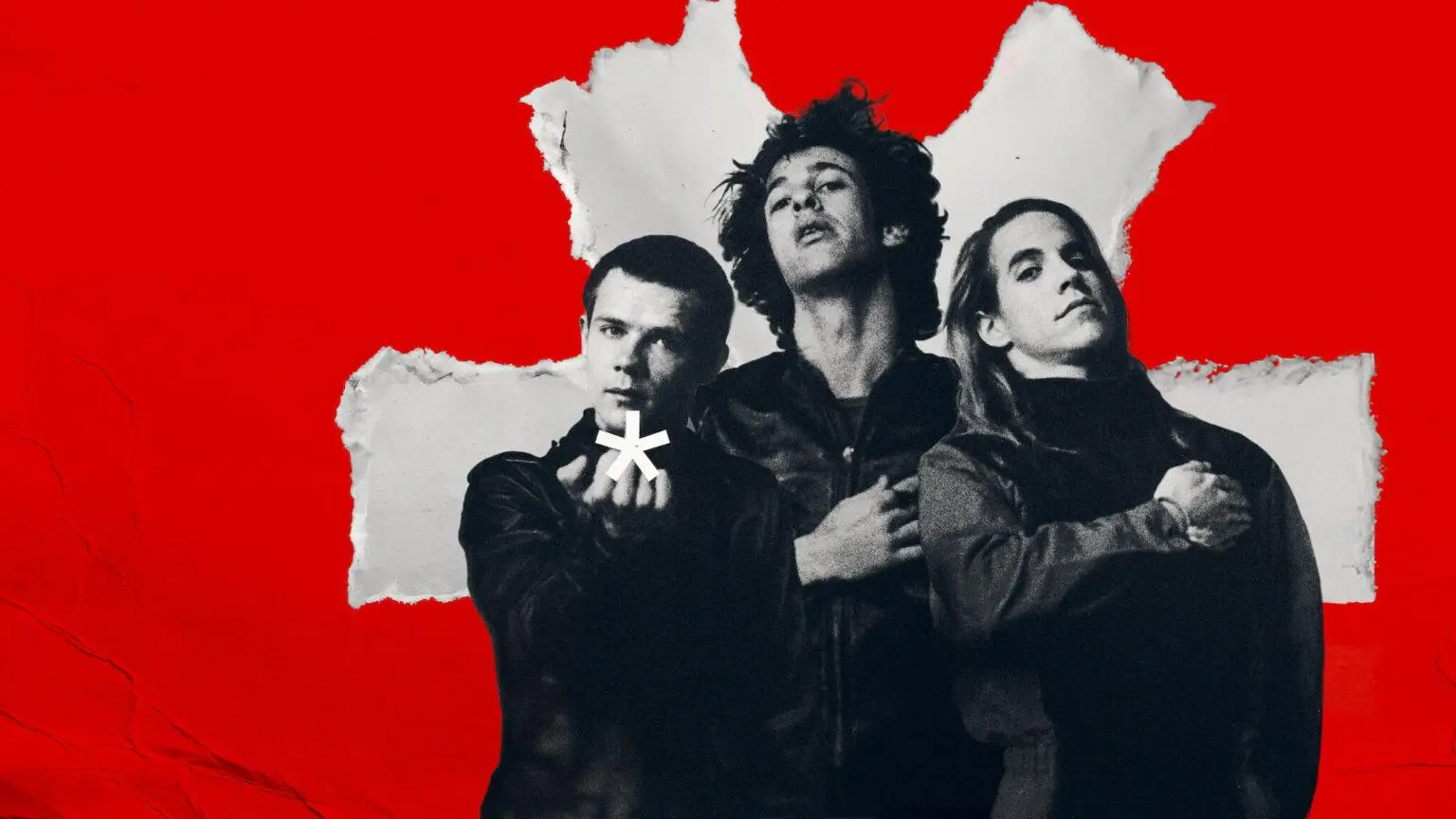 Early lineup of the Red Hot Chili Peppers featuring Anthony Kiedis, Flea, and Hillel Slovak posed against a bold red background with the band’s iconic asterisk symbol, evoking the group’s raw beginnings and enduring brotherhood