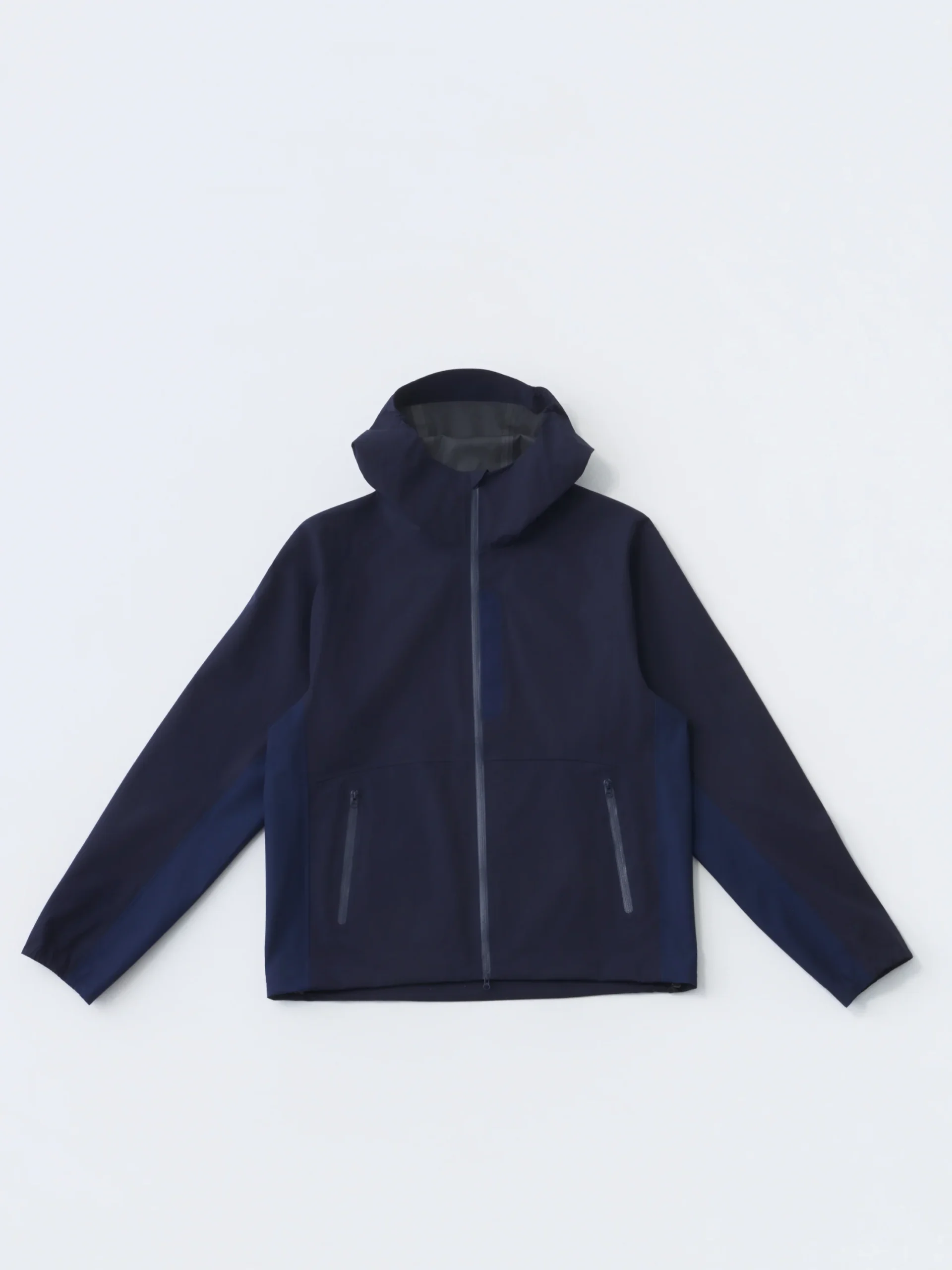 Hiking Patrol ARC LT Weight Shell Jacket 2.0 in dark navy, a minimalist lightweight waterproof shell with hood, front zip closure, and two zippered hand pockets on a neutral studio background