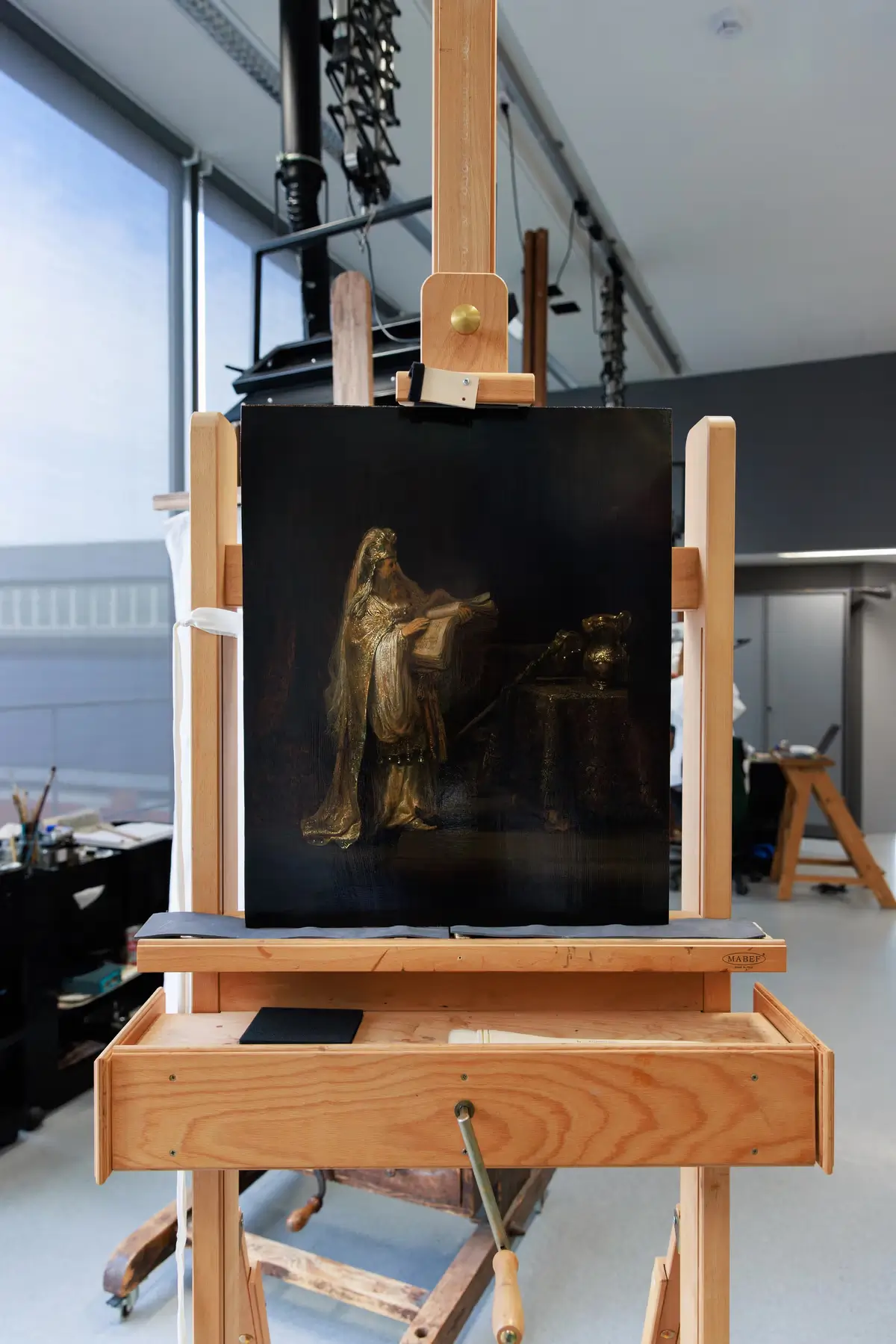 Vision of Zacharias in the Temple (1633) by Rembrandt van Rijn displayed on a wooden easel inside the Rijksmuseum conservation studio during authentication analysis