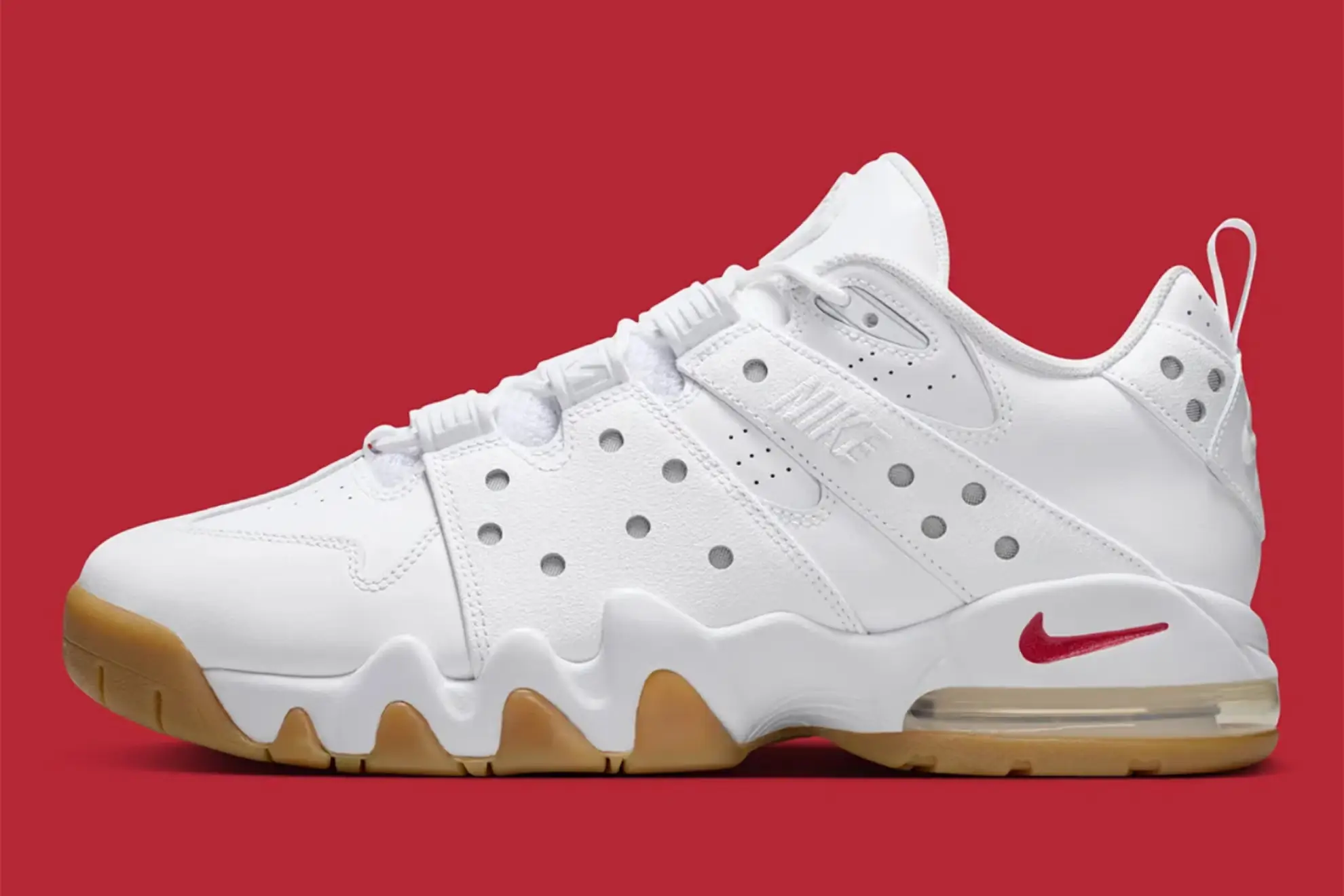 Supreme x Nike SB Air Max CB 94 Low in White and Gum with red Swoosh, visible Air unit, and perforated leather upper against red background