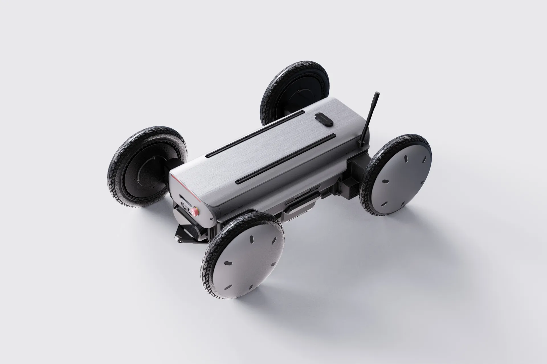 A compact, four-wheeled robotic platform by Hyundai featuring a rectangular brushed-metal body with rounded edges, mounted on independently articulated wheels with thick rubberized treads. Each wheel is positioned on adjustable suspension arms, allowing the platform to remain level across uneven terrain. A minimal antenna-like sensor protrudes from one corner, while subtle industrial detailing—vents, seams, and control elements—reinforces its function as a precision mobility device designed for autonomous transport and stabilization tasks