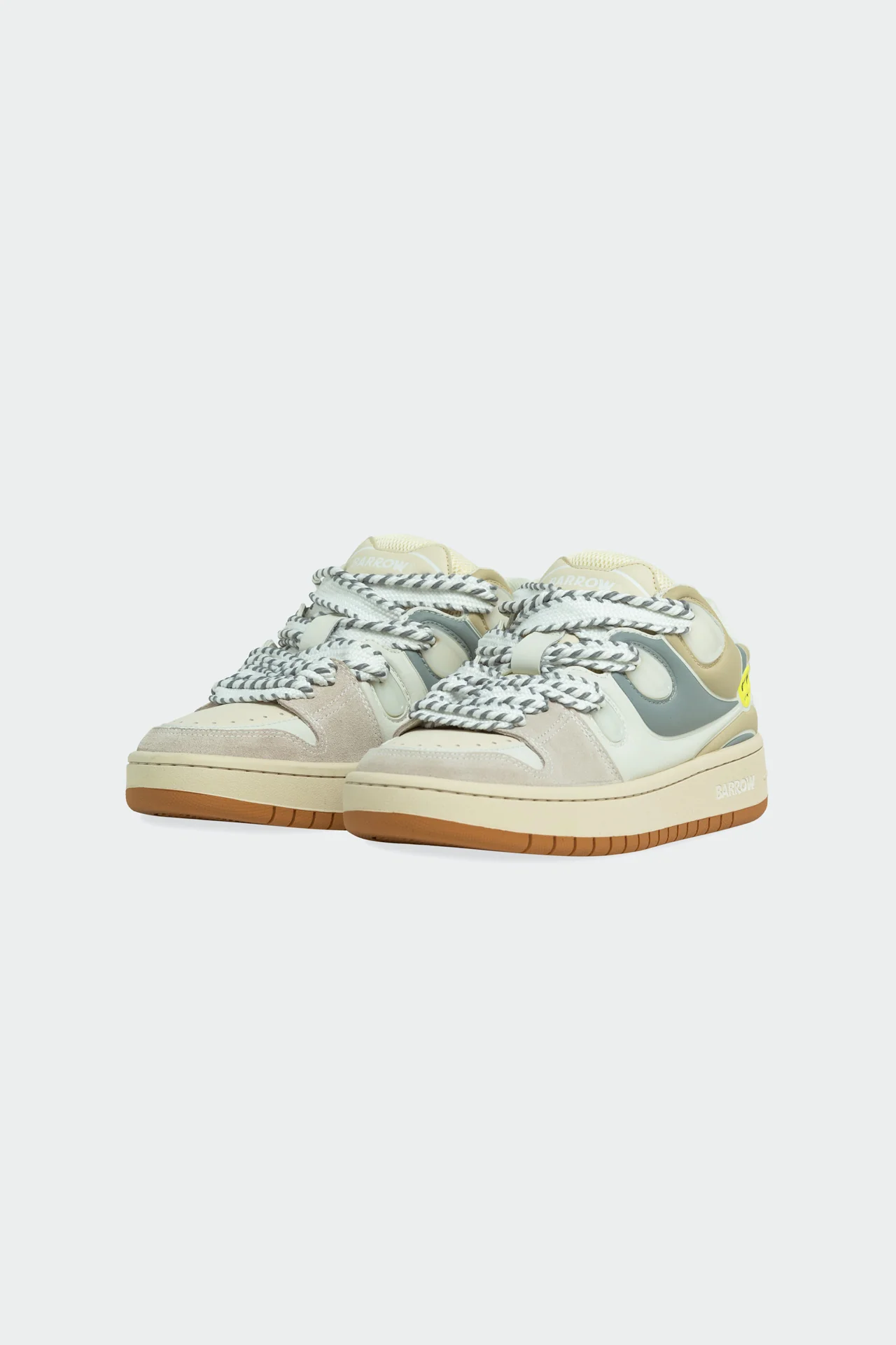 Barrow OFF WHITE–TURTLEDOVE unisex skate shoes in layered suede and leather with soft beige and muted grey panels, featuring oversized braided laces, a cushioned midsole, and gum rubber outsole against a neutral studio background