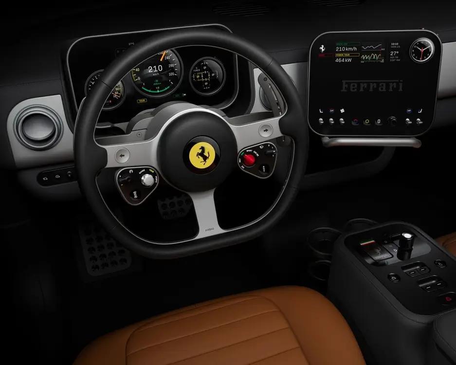 Interior cockpit view of the Ferrari Luce electric supercar showing a minimalist steering wheel with Ferrari emblem, digital instrument cluster, floating dashboard display, and sleek center console between tan leather seats