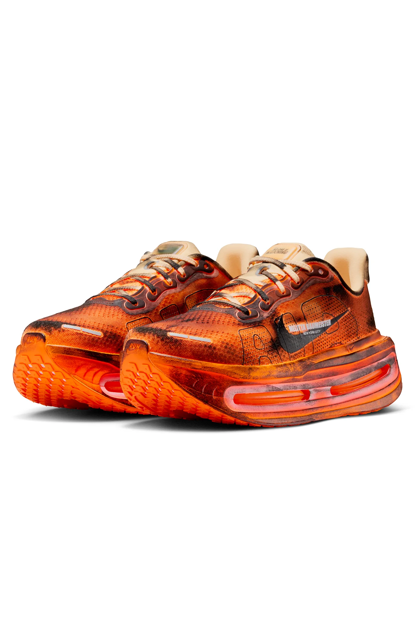 Three-quarter angled view of the Melitta Baumeister x Nike Vomero Premium in Total Orange, highlighting the distressed upper, co-branded Swoosh detail, and exaggerated sculptural Air unit midsole