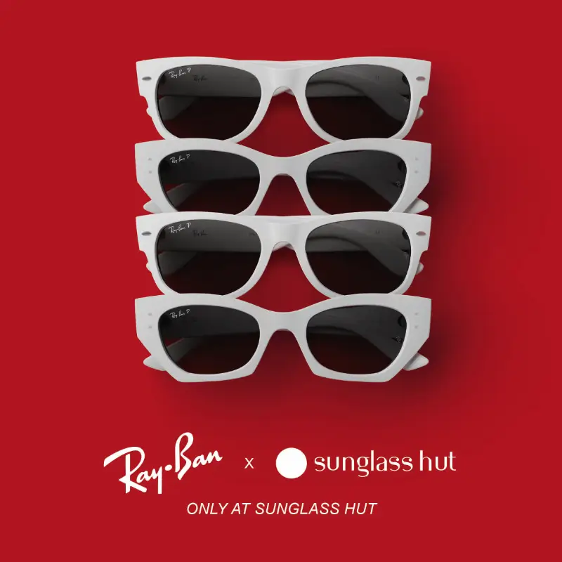 Stacked white-frame Ray-Ban sunglasses with dark gray lenses against a bold red background, promoting the Sunglass Hut exclusive global capsule collection