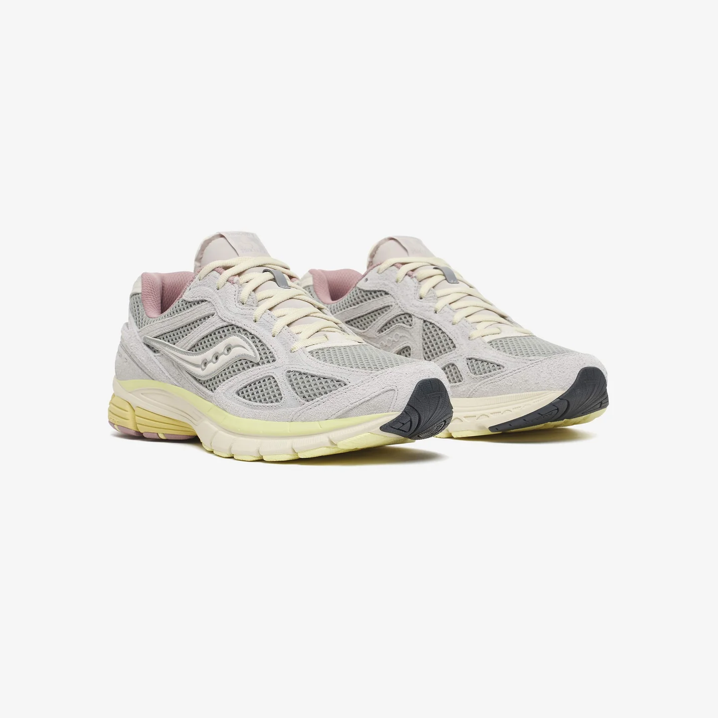 Pair of Saucony x 3sixteen Guide 7 “Graphite” sneakers in light grey suede and mesh with cream laces, subtle pink lining, and segmented ProGrid midsole on a clean studio background