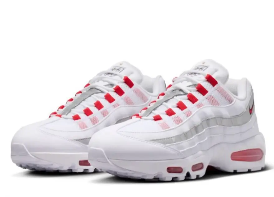 Pair of Nike Air Max 95 SE sneakers in White / Speed Red / Metallic Silver shown in angled front view with red lace loops, metallic silver wave panels, and visible red Air cushioning