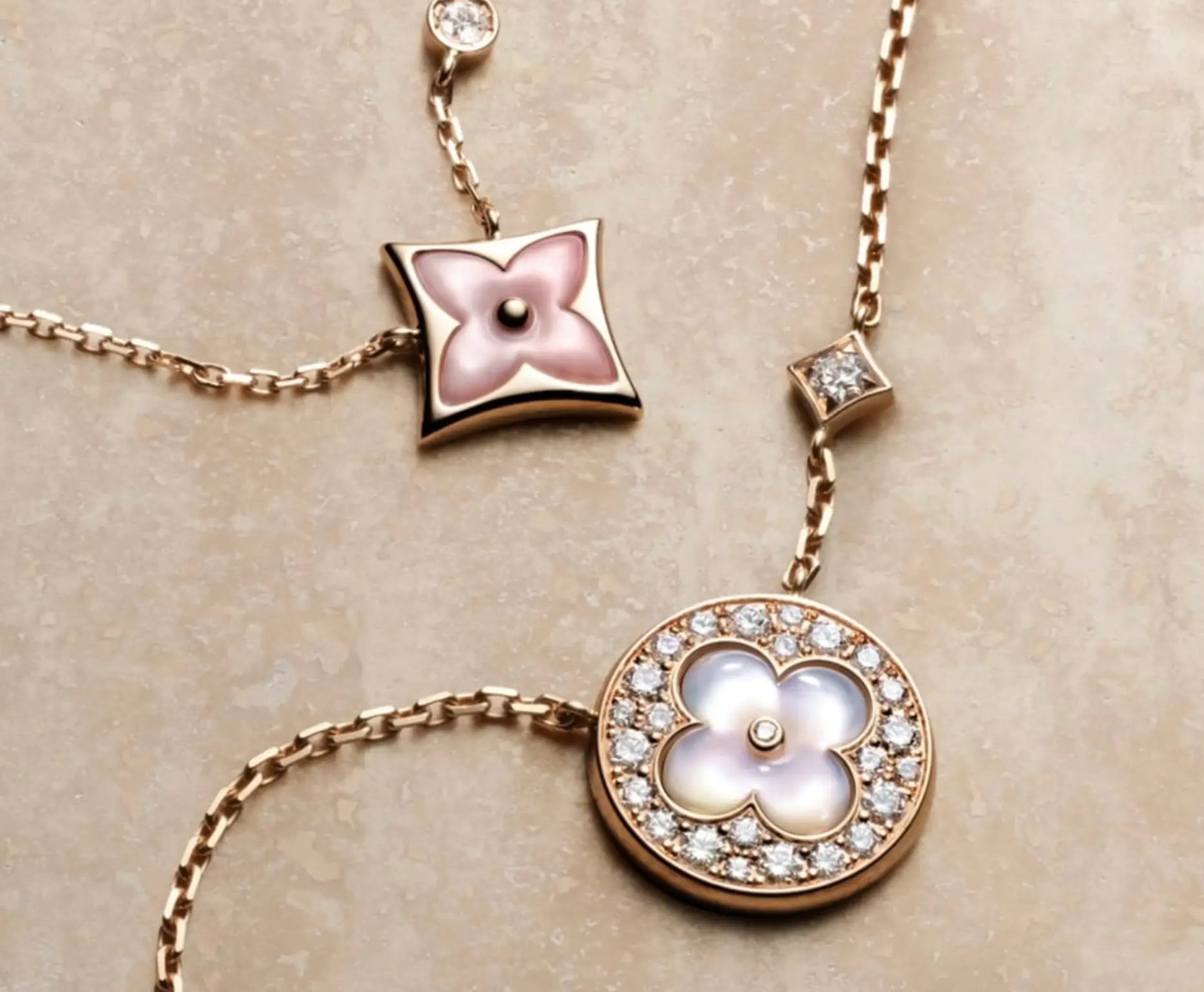 Louis Vuitton Colour Blossom fine jewelry necklaces featuring monogram flower pendants in pink mother-of-pearl set in polished gold, accented with pavé diamonds and delicate chain links in a refined haute close-up
