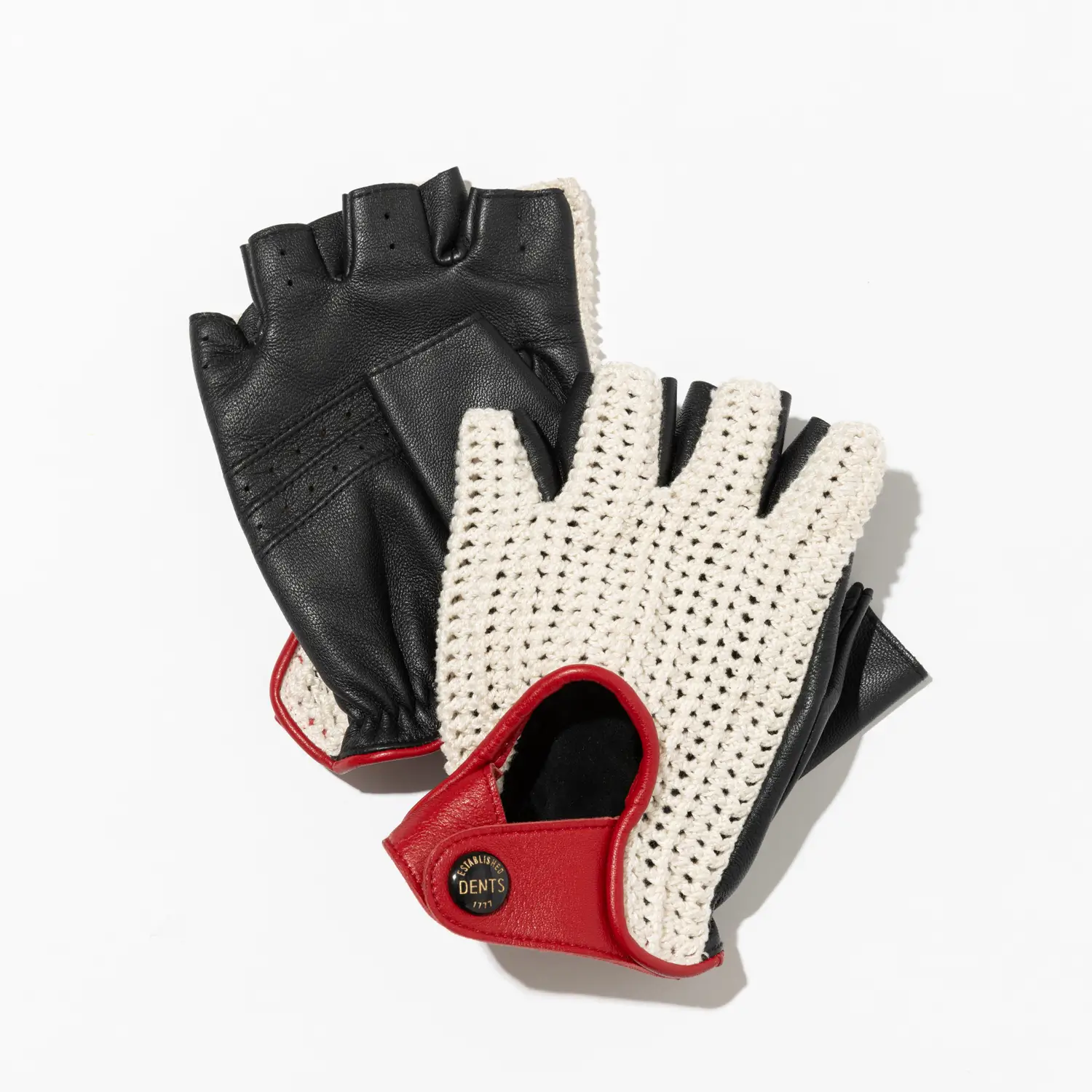 Pair of fingerless driving gloves featuring black leather palms and cream crochet backs with red leather trim and snap-button closure, arranged on a clean white background