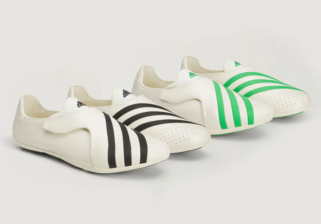 Pharrell Williams adidas VIRGINIA Vario “Flat Earther” sneakers in off-white with black and green Three Stripes, shown in a low-profile slip-on silhouette
