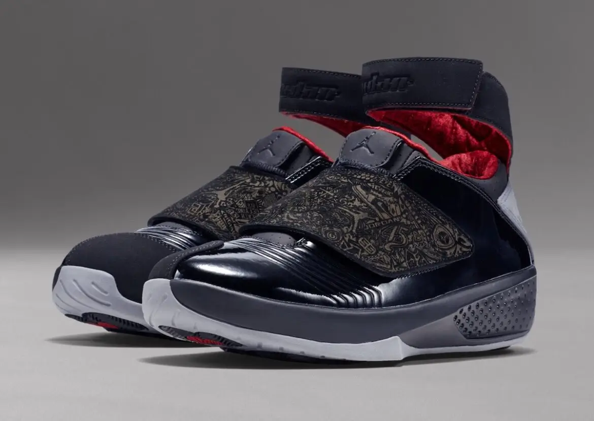 Pair of Air Jordan 20 “Stealth” sneakers from the 2015 retro release featuring a black leather upper, tonal laser-etched storytelling graphics on the shroud, adjustable midfoot strap, grey outsole pods, and red interior lining