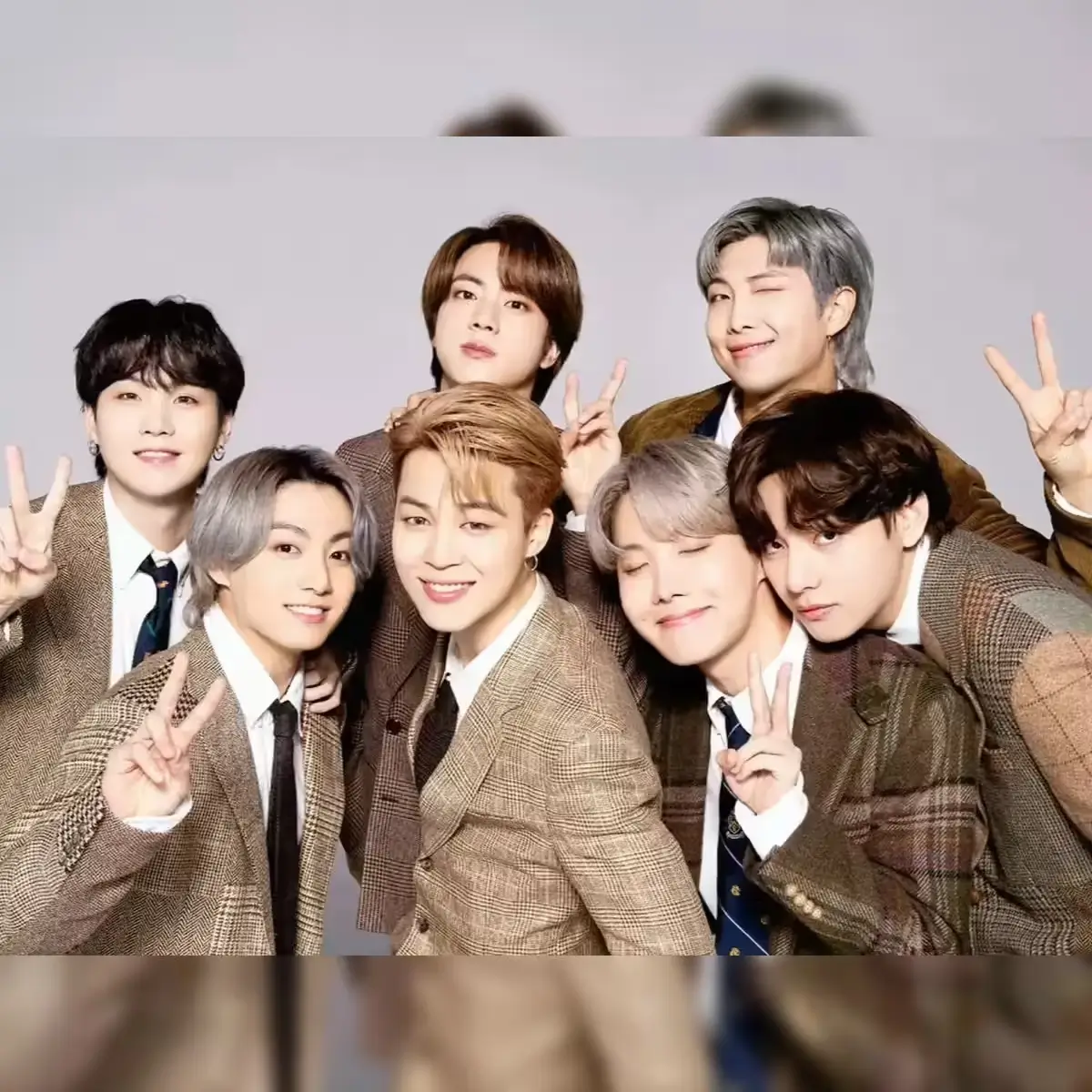 BTS group portrait ahead of their 2026 comeback, styled in modern tailored outfits with a refined, minimalist aesthetic