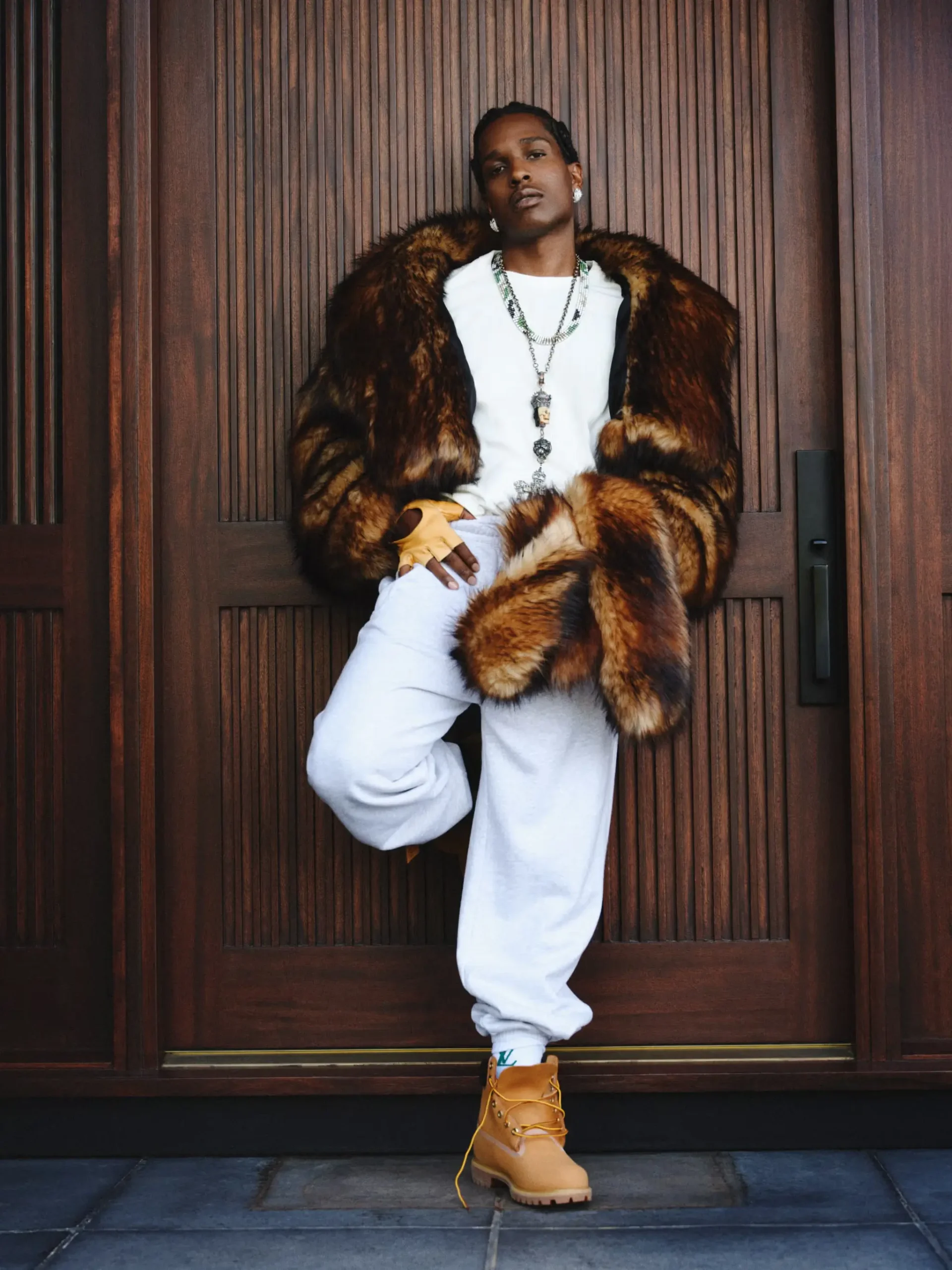A$AP Rocky in a cinematic close-up portrait, wearing a tailored dark coat with refined styling, set against a moody, minimalist background reflecting the Don’t Be Dumb era aesthetic