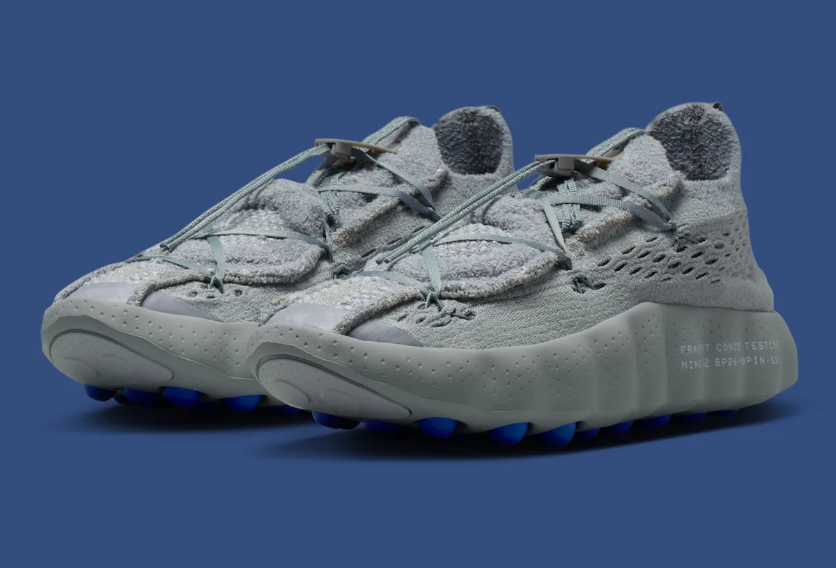 Pair of Fragment x Nike Mind 002 “Particle Grey” sneakers featuring textured Flyknit uppers, toggle lacing system, and blue sensory outsole nodes