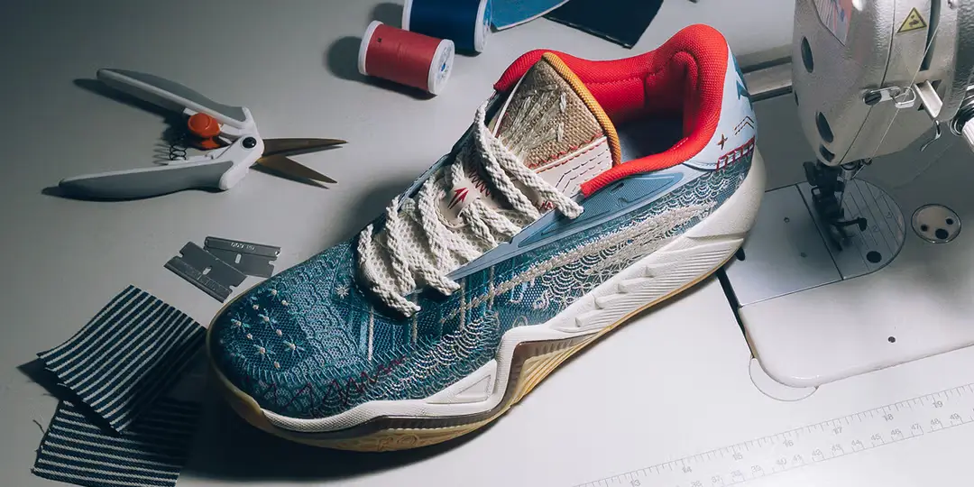 Close-up of ANTA KAI 3 Patchwork sneaker showing layered blue upper, off-white stitching, and Kyrie Irving branding details