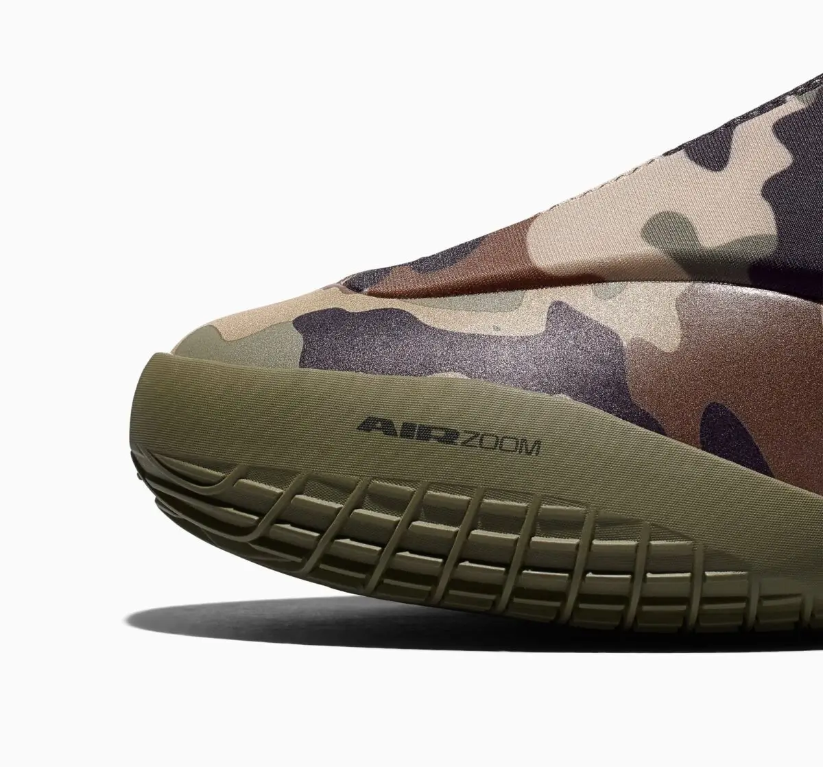 Close-up of the Converse SHAI 001 “Camo” forefoot showing tonal camouflage upper, olive midsole with “AIR ZOOM” branding, and textured rubber outsole with flex grooves