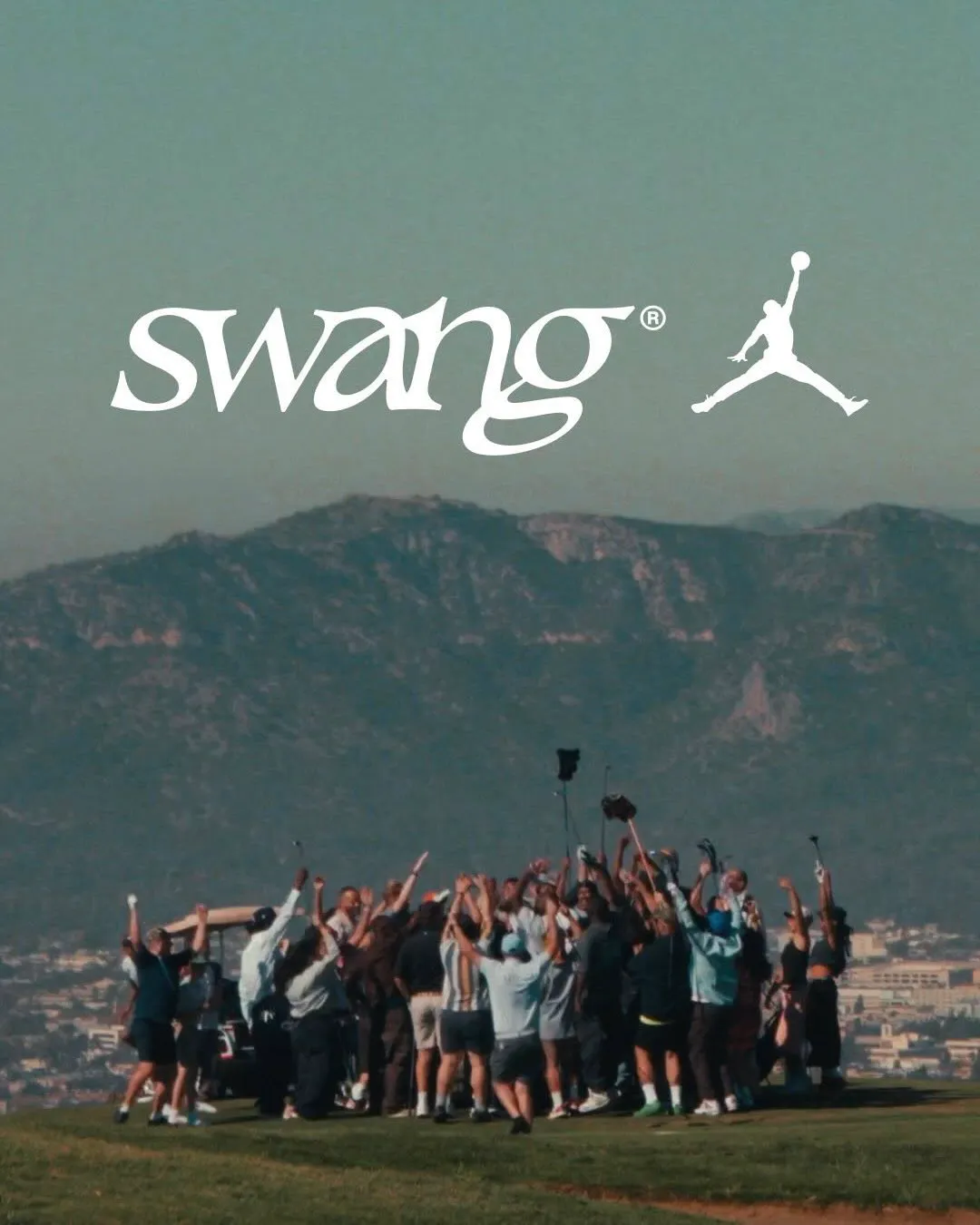 A large group of golfers gathers on a Los Angeles hilltop course, raising their arms in celebration beneath a hazy mountain backdrop, with the swang logo and Jordan Jumpman mark overlaid above, capturing a collective, culture-driven approach to the game