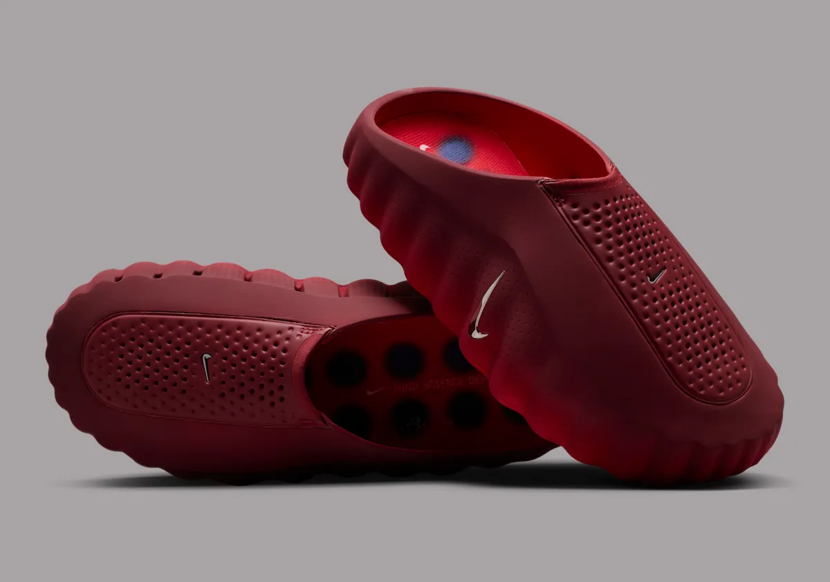 Nike Mind 001 “Team Red” slip-on mule in sculpted red foam with perforated upper, chrome Swoosh detail, and visible circular pressure nodes inside the footbed