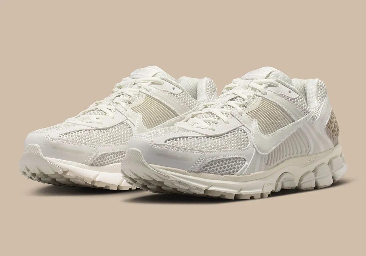 Angled view of the Nike Zoom Vomero 5 “Phantom” pair, highlighting breathable mesh construction, layered tonal overlays, and cushioned sole unit in soft cream and sail tones, emphasizing a clean, versatile summer-ready design