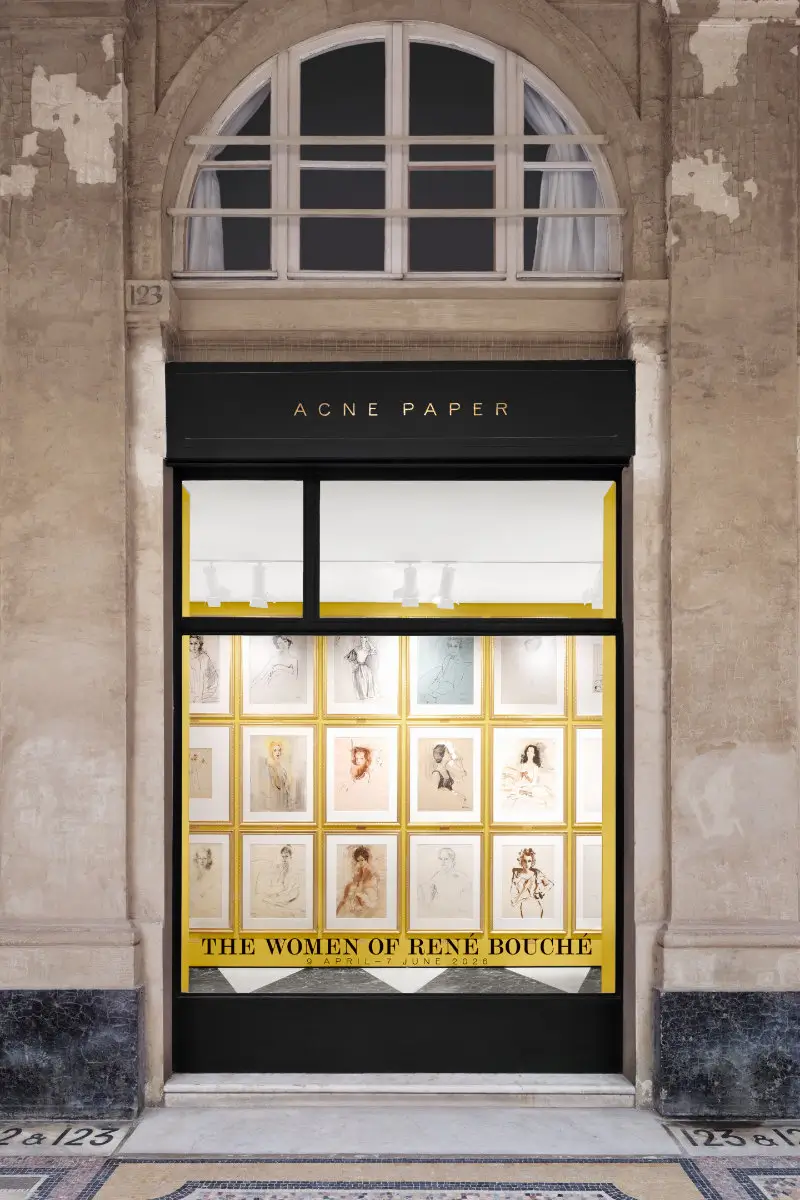 Storefront display for Acne Paper featuring “The Women of René Bouché” exhibition, with framed portrait drawings arranged in a grid behind glass
