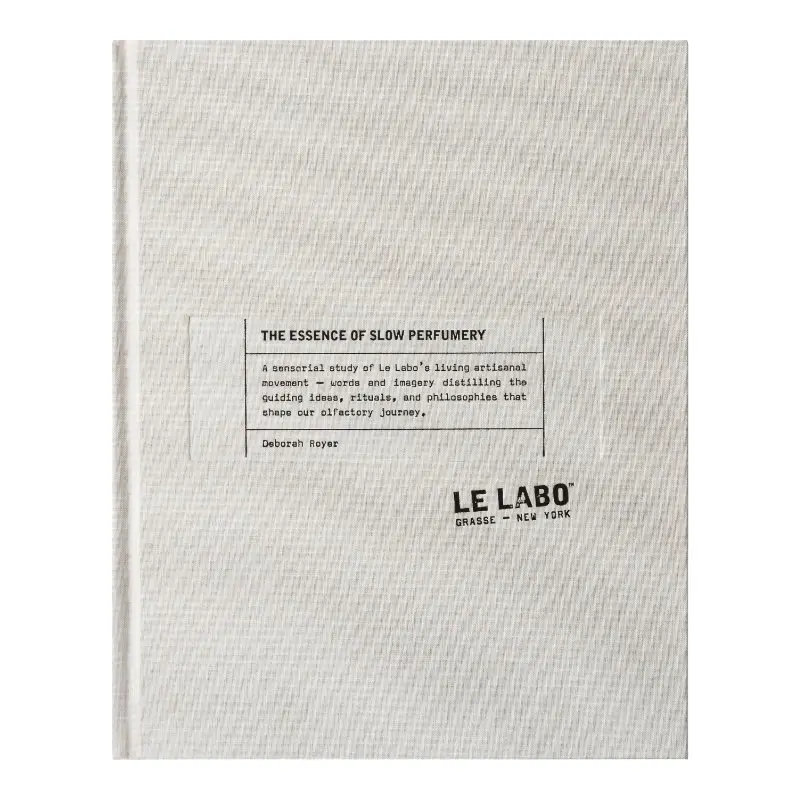 Cloth-bound cover of The Essence of Slow Perfumery by Deborah Royer for Le Labo, featuring minimalist typography, textured linen surface, and the brand’s Grasse–New York imprint