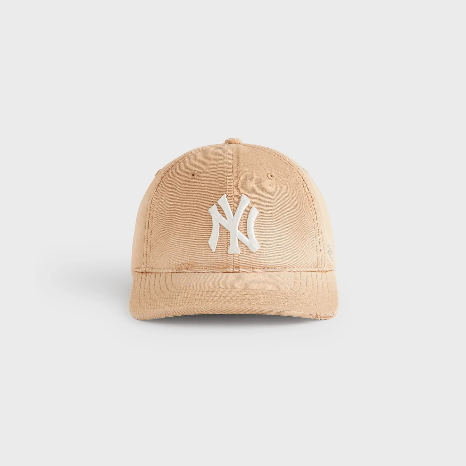 Light beige Kith x ’47 Franchise LS cap with a sun-washed finish, featuring soft fading across the crown and brim, subtle distressing along the edges, and a raised off-white embroidered New York logo centered on the front against a neutral background