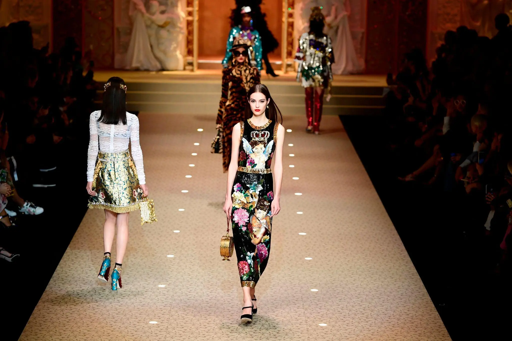 Layered, abstract composition combining a laptop keyboard and a digital interface overlay with sliders and data panels, partially revealing a fashion runway scene beneath, blending technology visuals with haute couture imagery